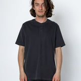 Man wearing a black t-shirt and pants against a white background