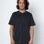 Man wearing a black t-shirt and pants against a white background
