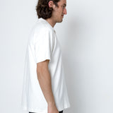 Person wearing a plain white t-shirt against a white background