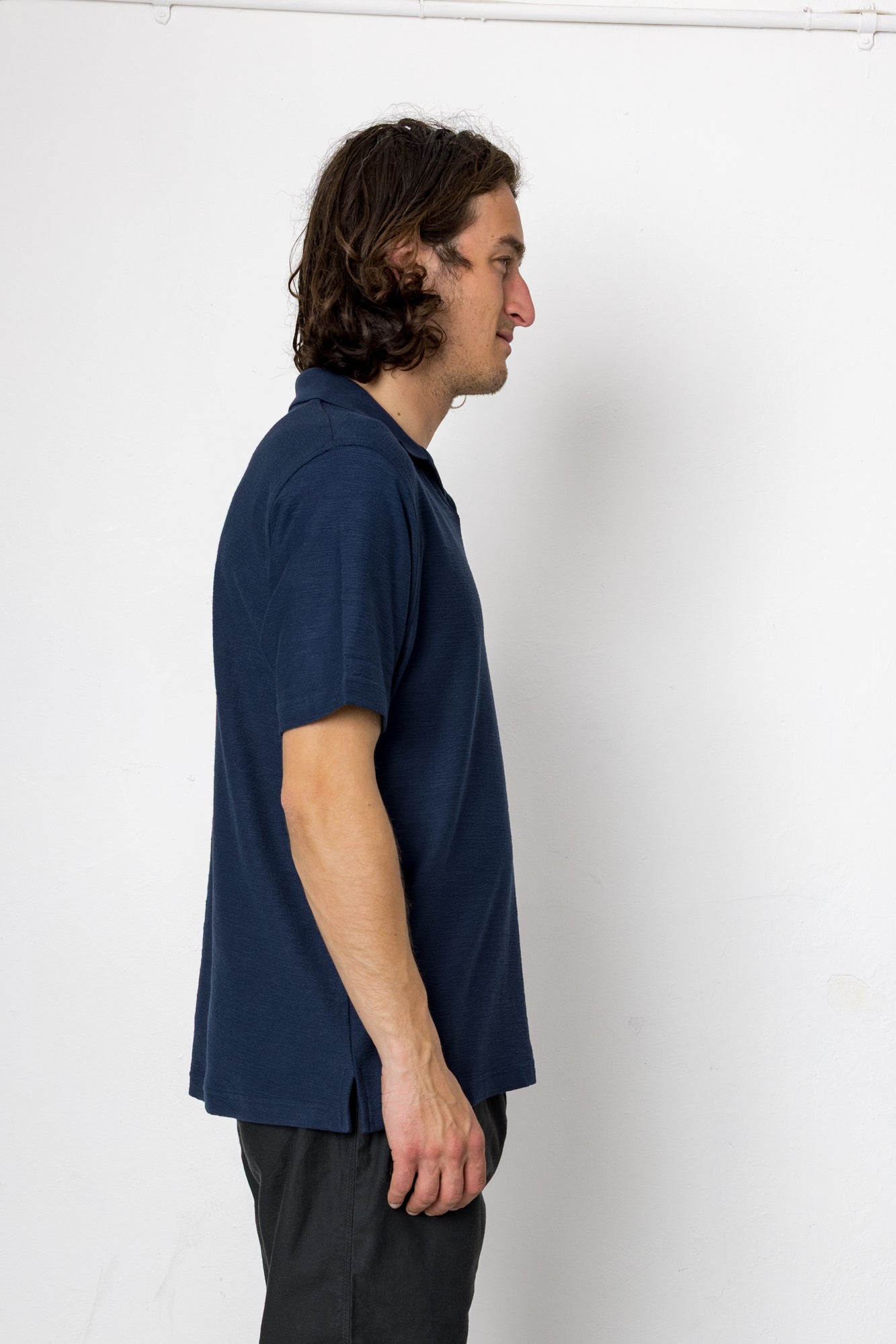 Man wearing a navy blue shirt against a white background