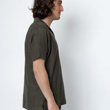 Man wearing a green shirt against a white background