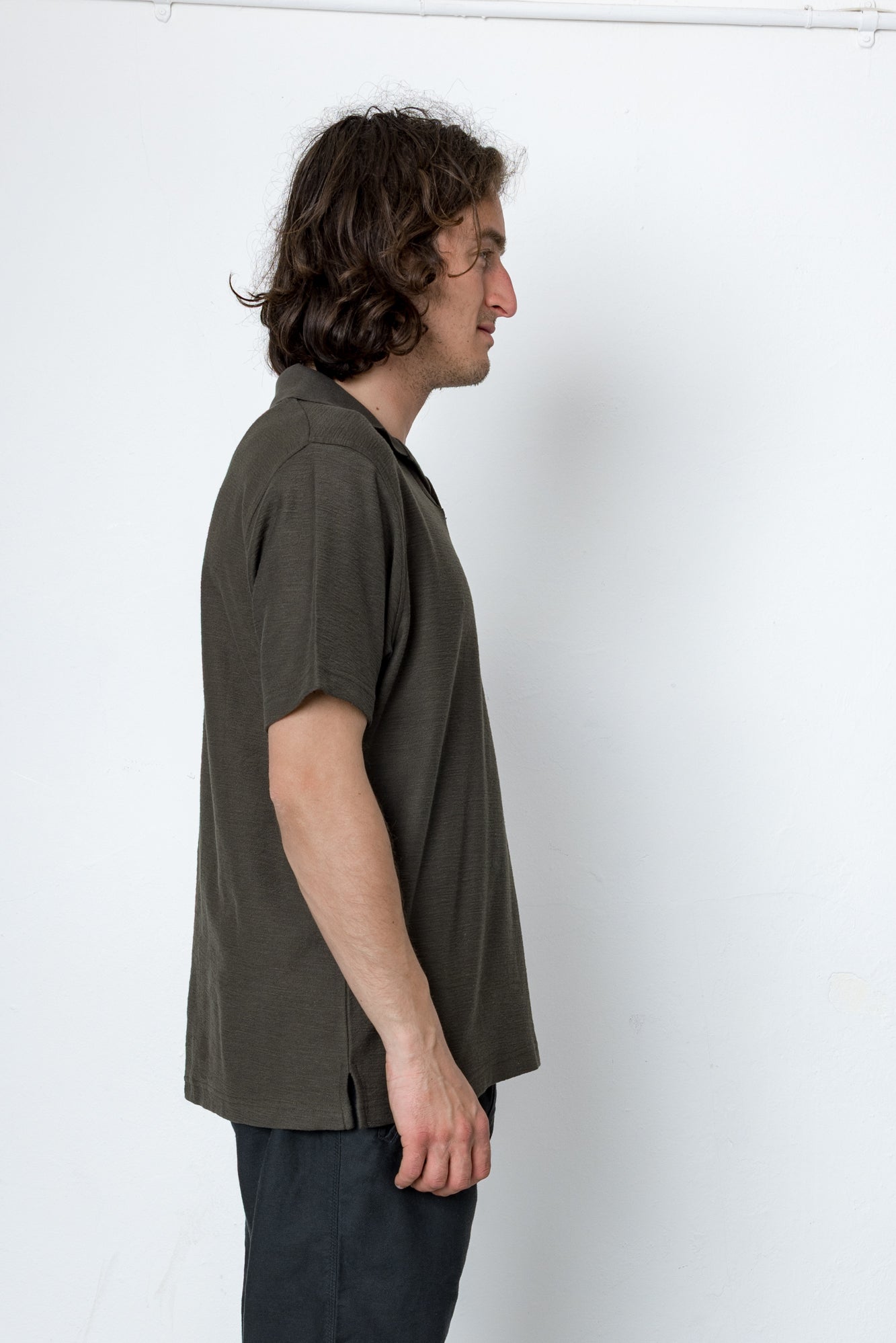 Man wearing a green shirt against a white background