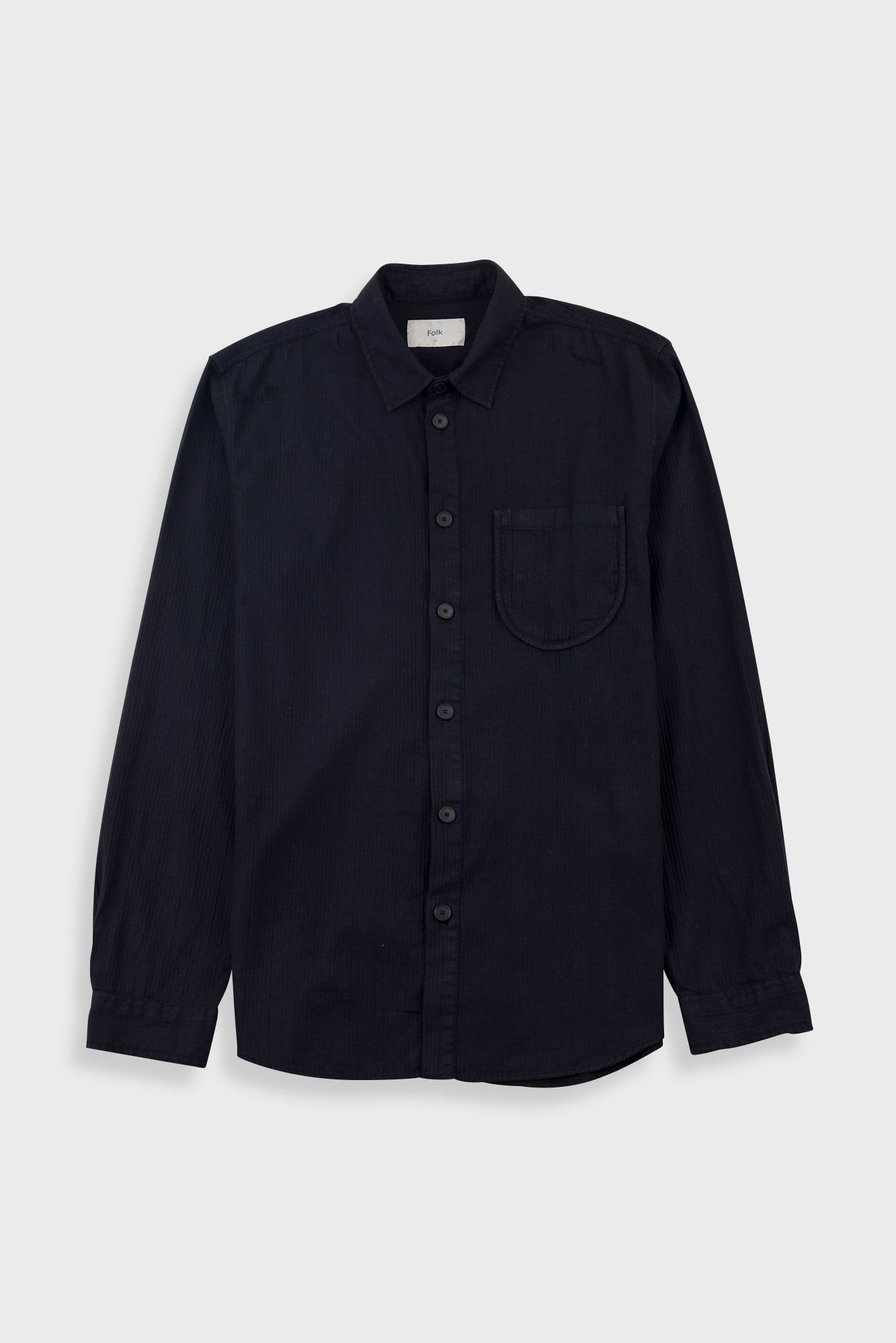 A dark navy blue long-sleeve button-up shirt with a single chest pocket, displayed flat against a light gray background.