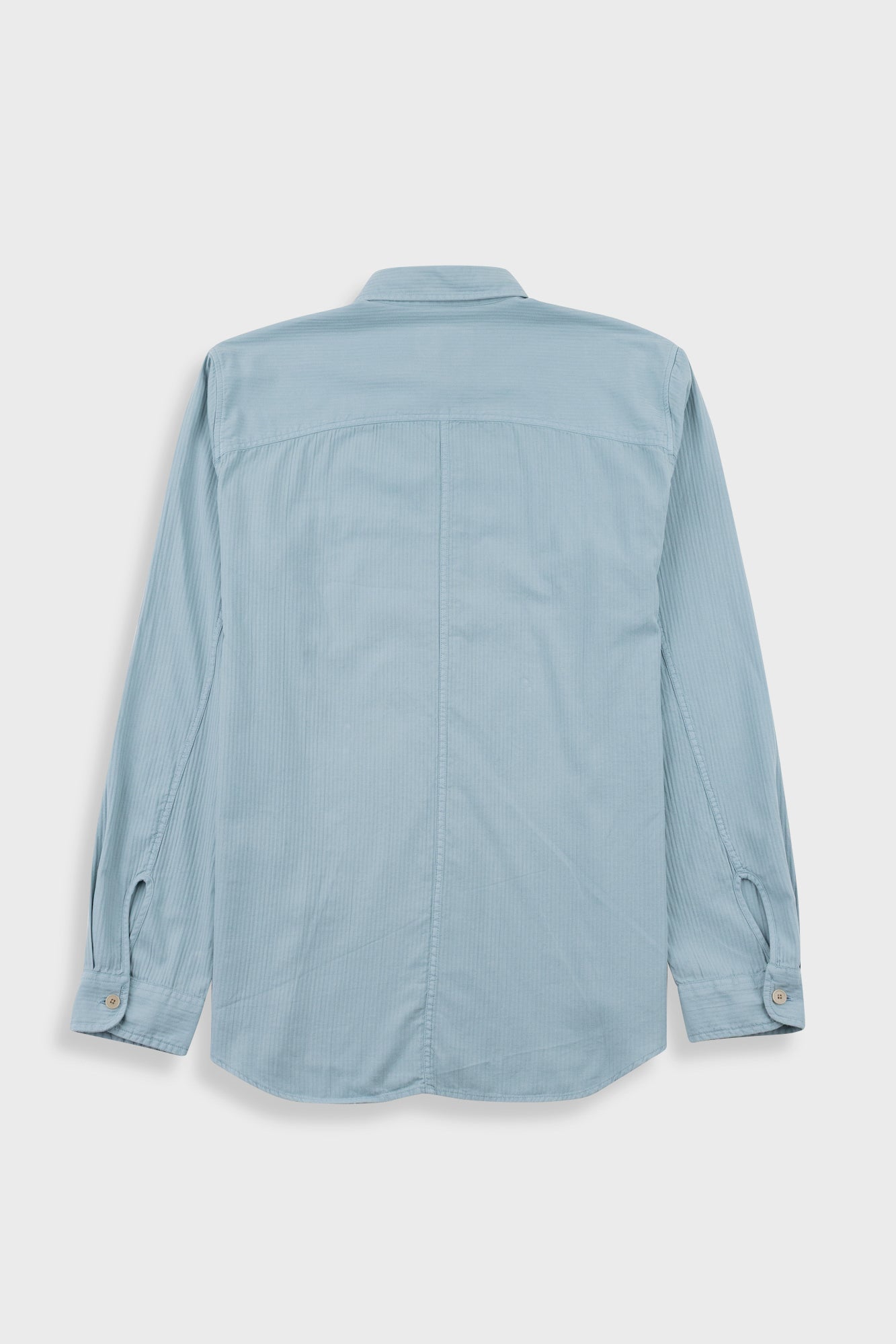 A light blue long-sleeve button-up shirt shown from the back, laid flat against a light gray background.