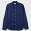 A navy blue long-sleeve button-up shirt with a single chest pocket, laid flat against a light gray background.