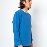 Person wearing a blue sweater against a white background