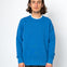 Man wearing a blue sweater against a white background