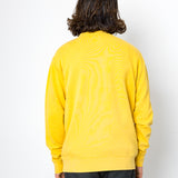 Person wearing a yellow sweater with a white background
