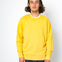 Person wearing a yellow sweatshirt against a white background