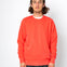 Person wearing a bright red sweatshirt against a white background