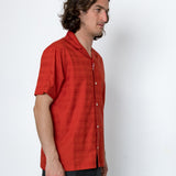 Man wearing a red shirt against a white background