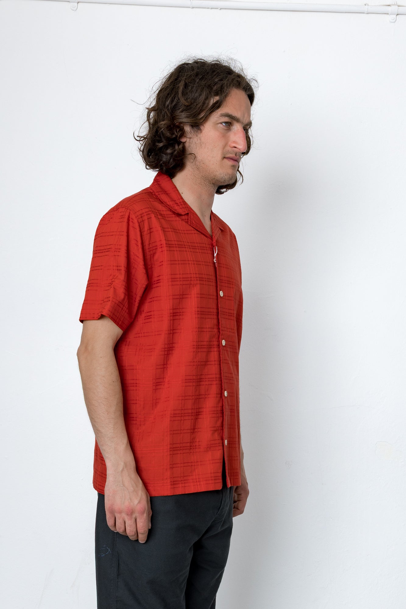 Man wearing a red shirt against a white background