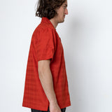 Person wearing a red shirt against a white background
