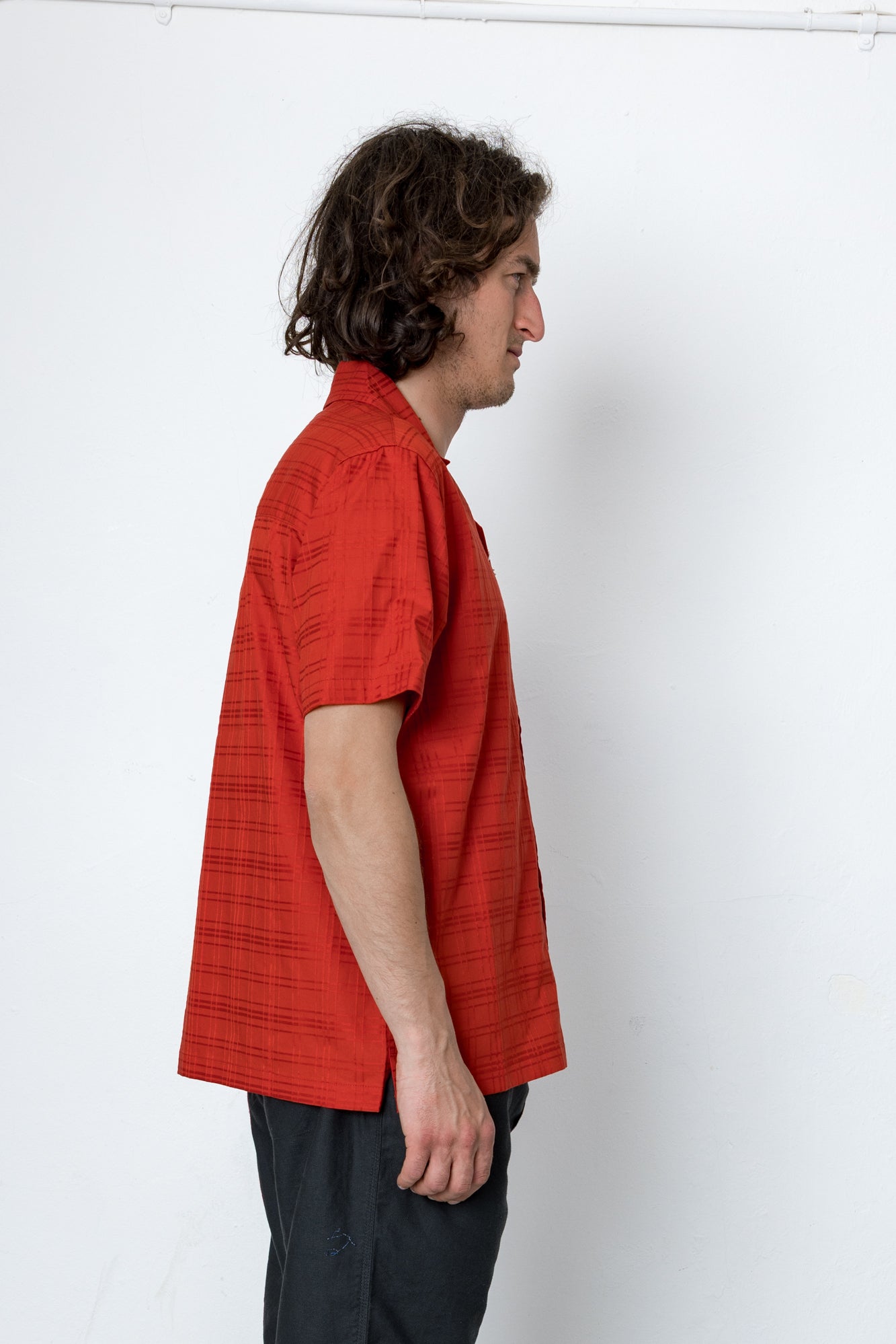 Person wearing a red shirt against a white background