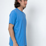 Man wearing a blue t-shirt against a white background