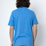Person wearing a blue t-shirt against a white background