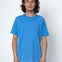Man wearing a blue t-shirt against a white background