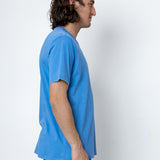 Man wearing a blue t-shirt against a white background