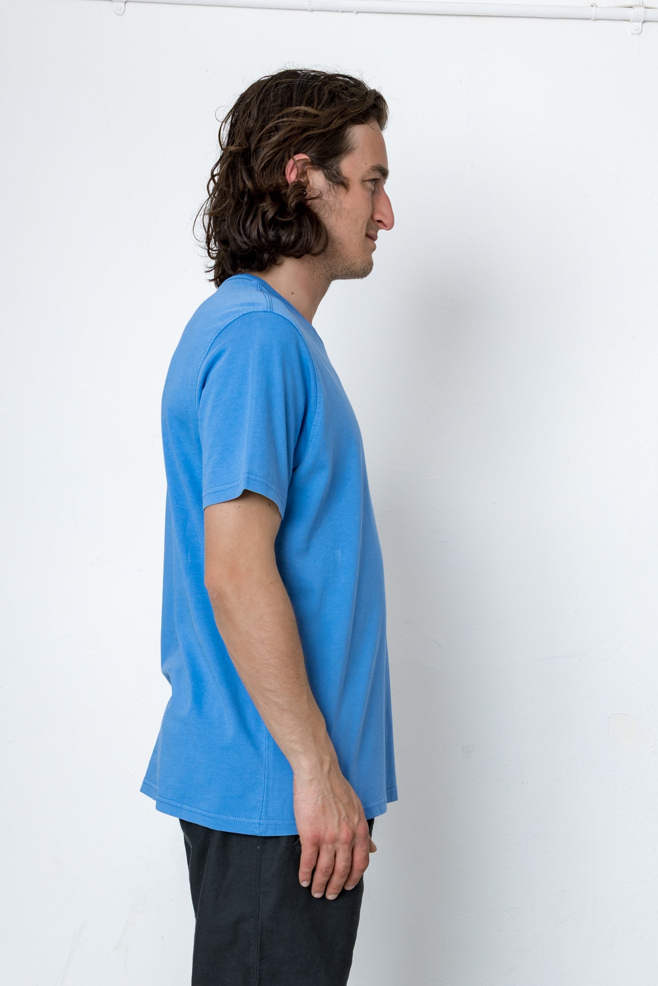 Man wearing a blue t-shirt against a white background