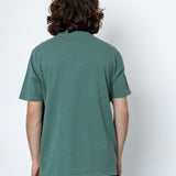 Person wearing a green t-shirt against a white background