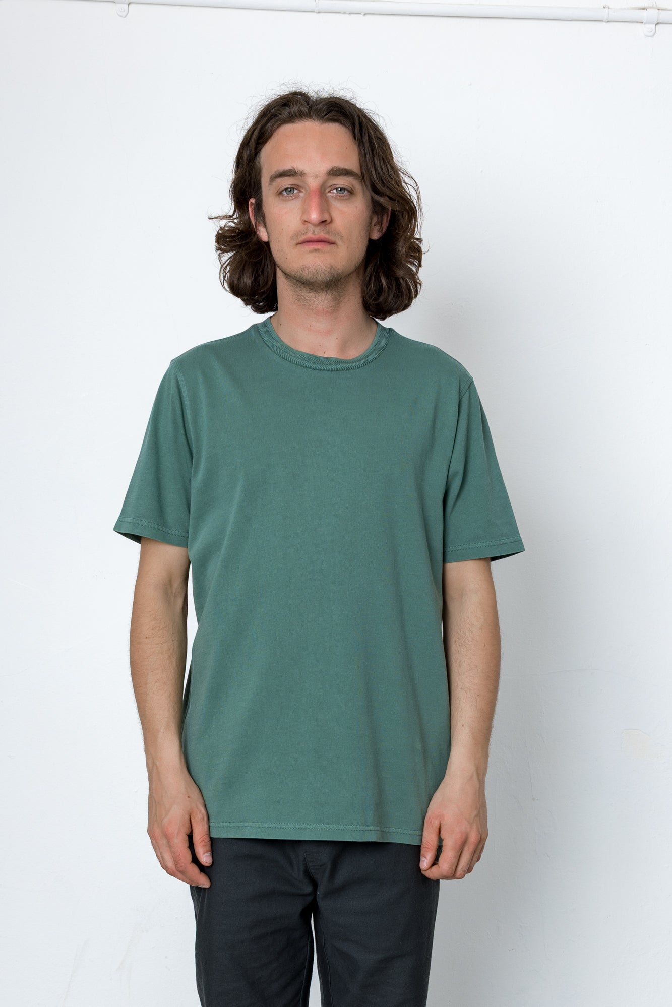 Man wearing a green t-shirt against a white background