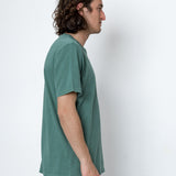Man wearing a green t-shirt against a white background