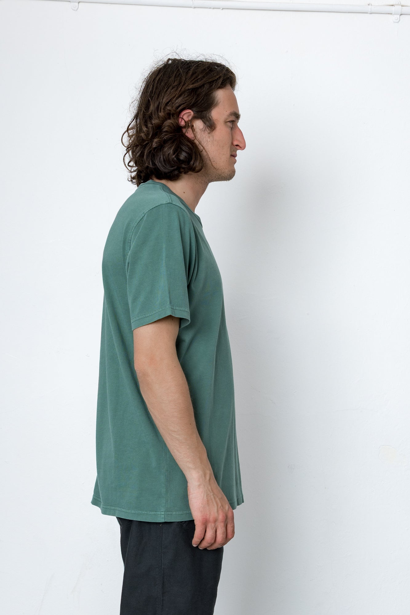 Man wearing a green t-shirt against a white background