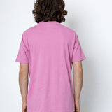 Person wearing a pink t-shirt against a white background