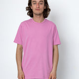 Person wearing a pink t-shirt against a white background