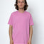 Person wearing a pink t-shirt against a white background