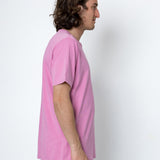 Person wearing a pink t-shirt against a white background