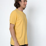 Man wearing a yellow t-shirt against a white background