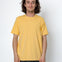 Person wearing a yellow t-shirt against a white background