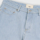 Close-up of light blue striped jeans with a brand label on a white background