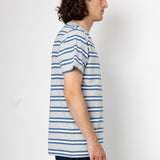 Person wearing a blue and white striped shirt against a plain background