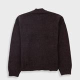 Dark brown sweater on a light gray background