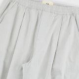 Light gray pants with a brand label on a light gray background