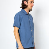Man wearing blue shirt and black trousers