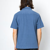 Person wearing a blue shirt from behind on a white background