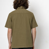 Person wearing an olive green shirt against a white background