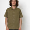 Man wearing an olive green short-sleeve shirt against a white background