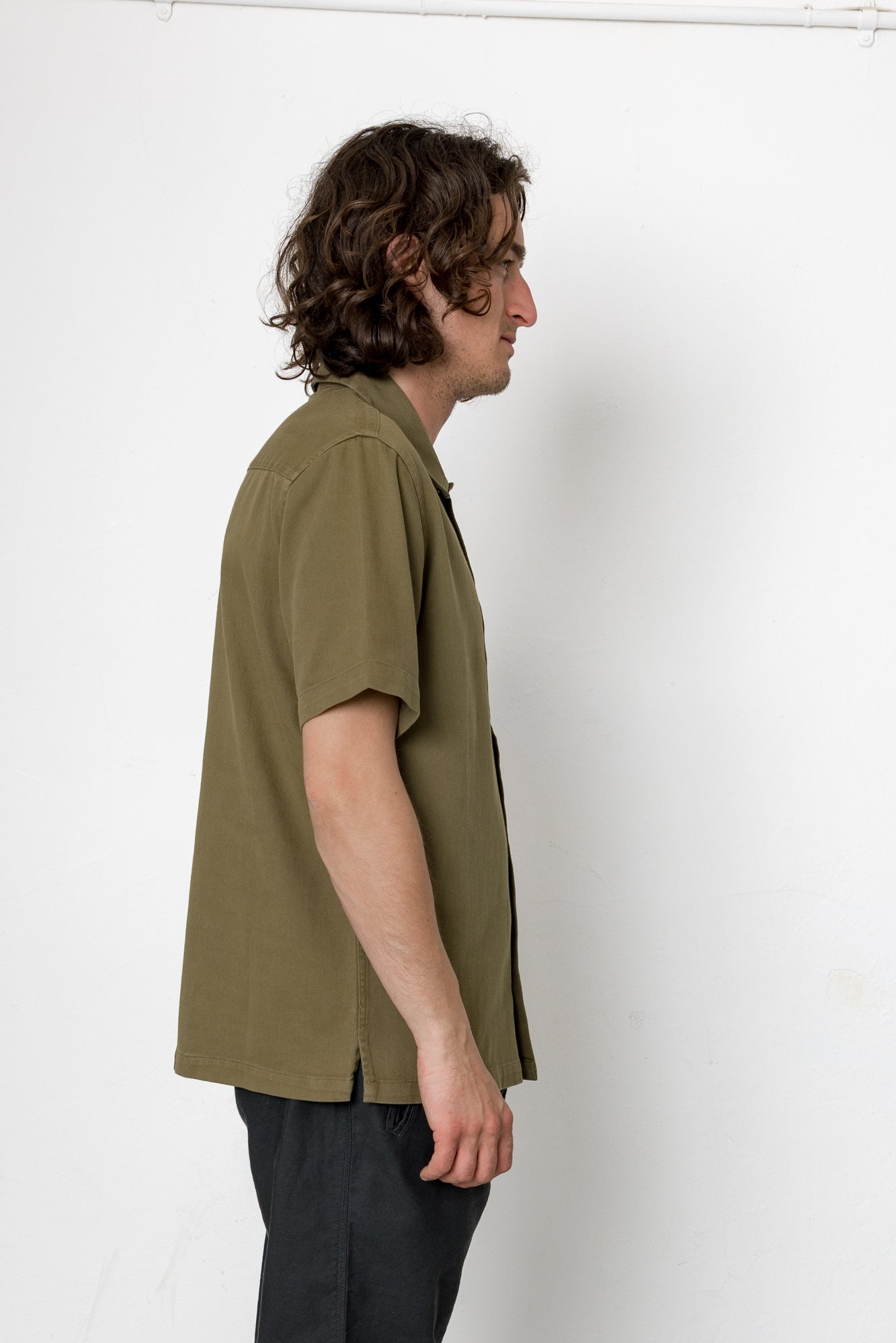 Man wearing a green shirt against a white background