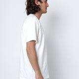 Man wearing a white t-shirt against a plain white background