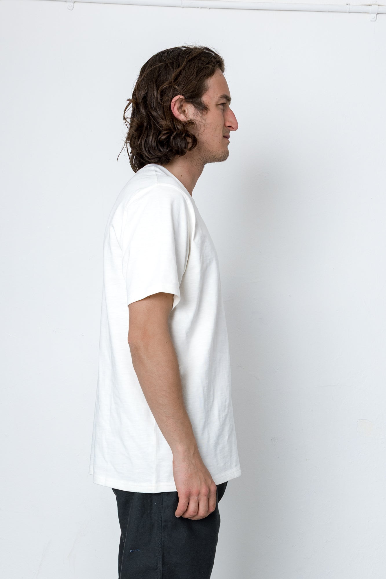 Man wearing a white t-shirt against a plain white background