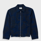 Navy blue jacket with a subtle pattern on a light gray background