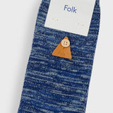 A single blue marled knit sock with a small brown leather triangle button featuring a wooden button, with a white paper header card that says 'Folk'.