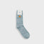 A single light blue and gray marled crew sock with a small yellow duck graphic and the brand name 'Fush' printed on the white cuff, shown against a light gray background.