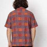Person wearing a plaid shirt with a white background