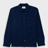 Navy overshirt with a visible brand label on a light gray background