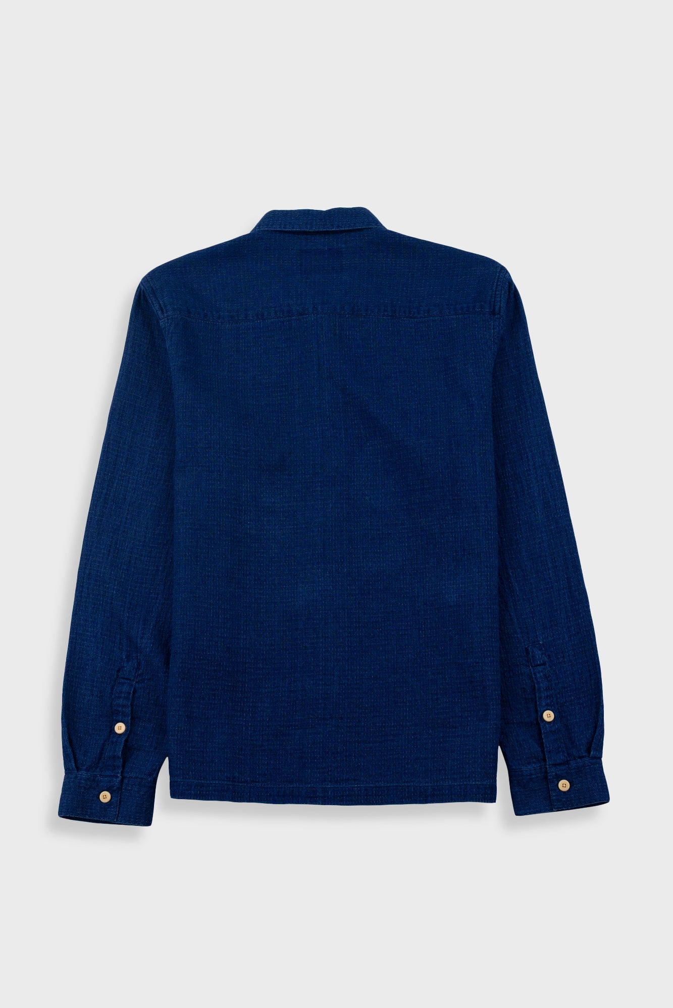 Blue shirt with buttons on a white background